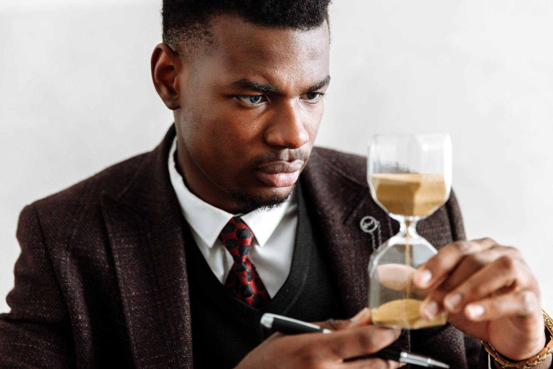 Business leader under time pressure with an hourglass